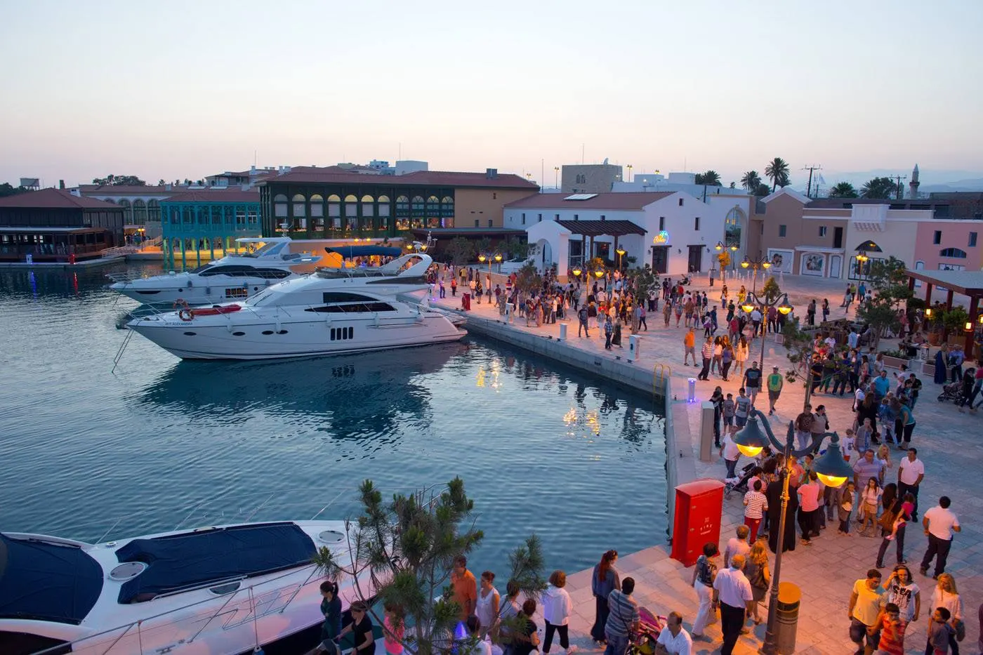 Limassol Marina promenade at dusk with yachts and waterfront restaurants