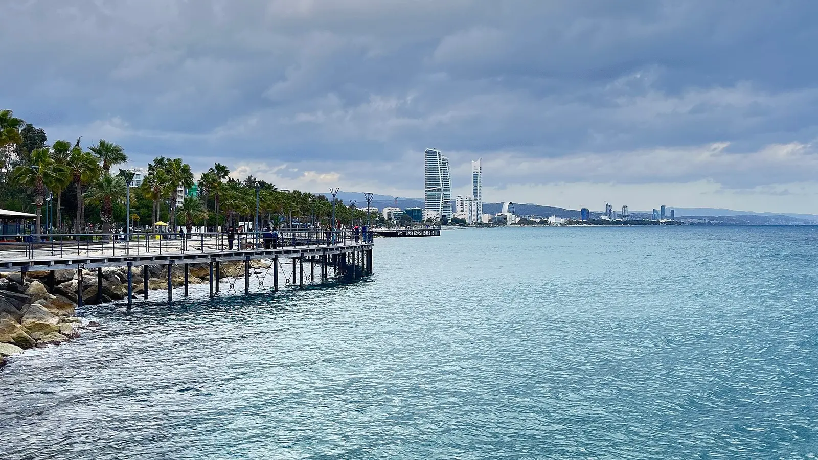 Molos seafront park pier in Limassol with the city skyline behind